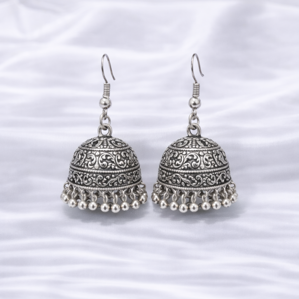 Antique silver jhumka earrings on satin