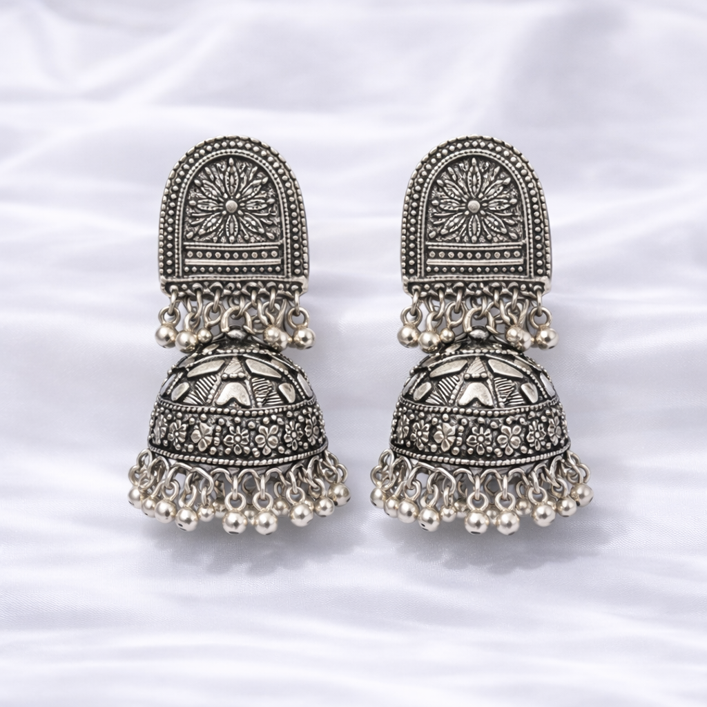 Antique silver jhumka earrings on fabric