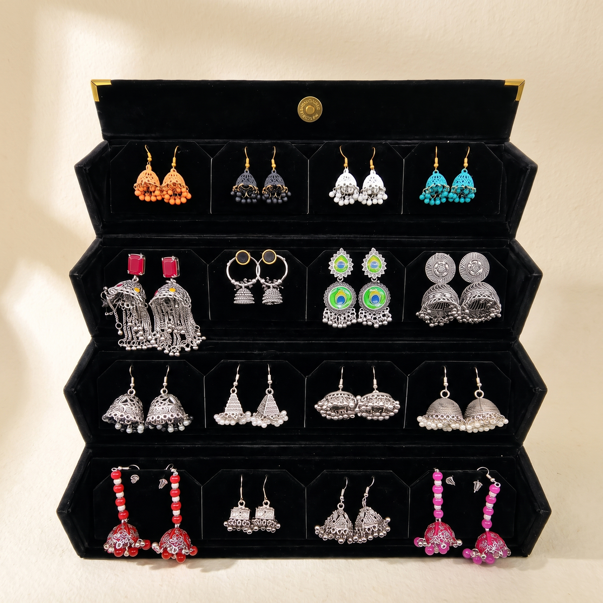Silver and colorful jhumka collection box on warm ivory paper