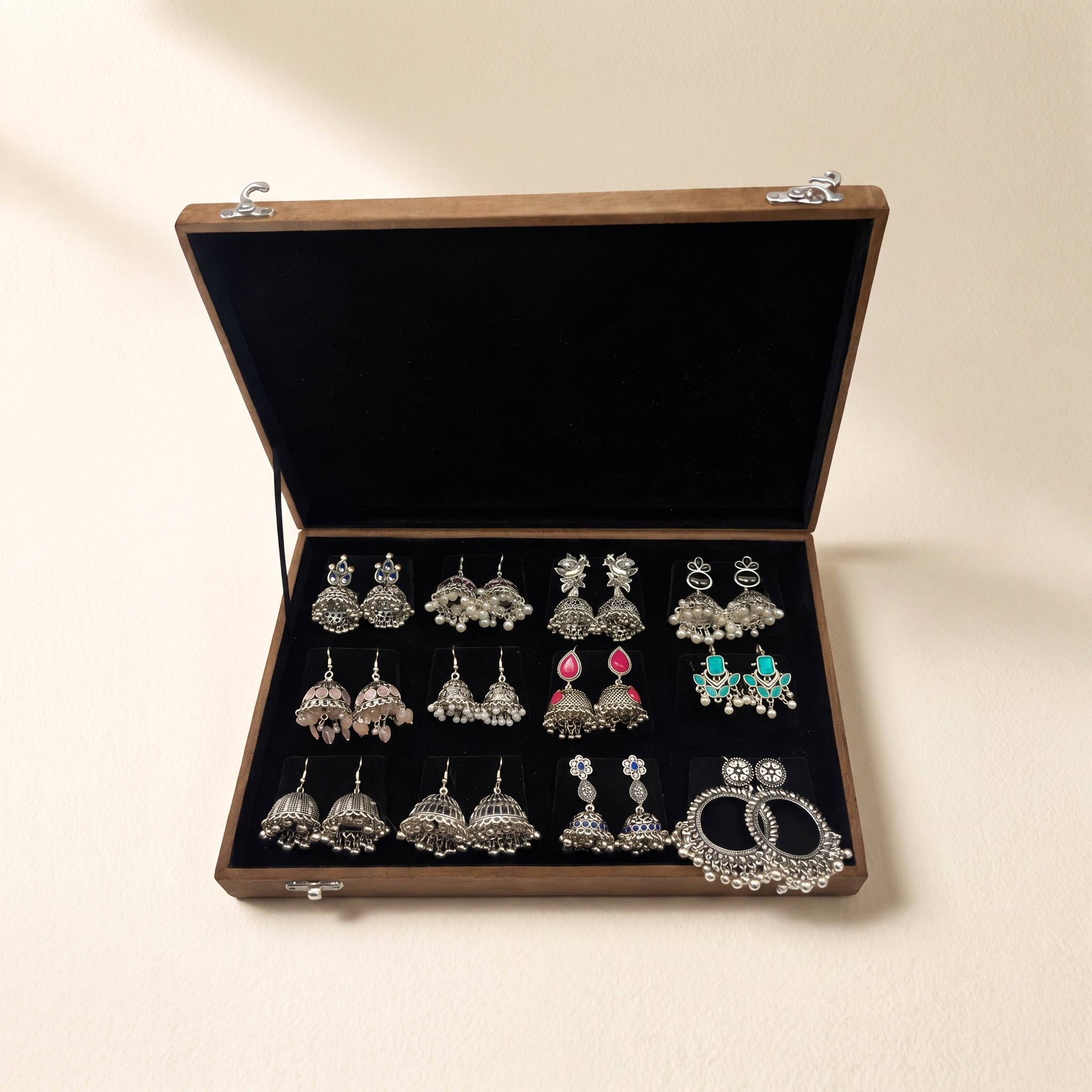 Oxidized jhumka earrings box on warm ivory paper